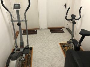 a gym with two exercise bikes in a room at Apartman Brzak in Zagreb