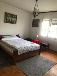 a bedroom with a large bed and a red table at Apartman Brzak in Zagreb +49 photos