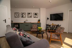 a living room with a couch and a table at Domek w Antoninie in Antonin