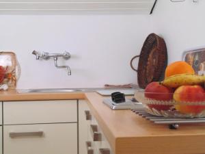 a kitchen with a bowl of fruit on a counter at Allgäu Sonne in Oberstdorf