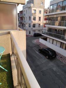 a black car parked on a balcony of a building at Magnifique appartement double cabine in Le Touquet-Paris-Plage +2 photos