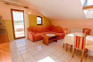 a living room with a couch and a table at Arka in Stara Novalja