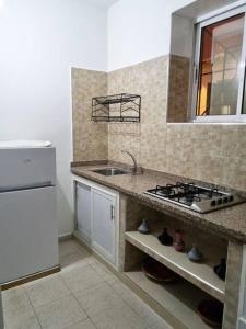 a kitchen with a sink and a stove in it at Maison l'océan in Rabat
