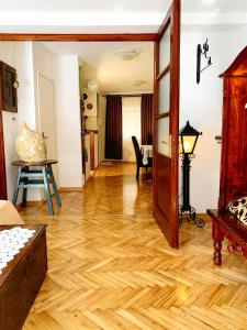 a living room with a wooden floor and a hallway at Villa Urbana, Old Town Budva in Budva