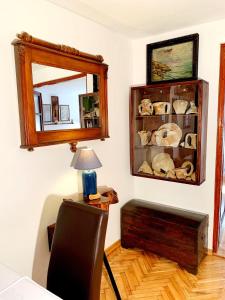 a room with a mirror and a table with a lamp at Villa Urbana, Old Town Budva in Budva