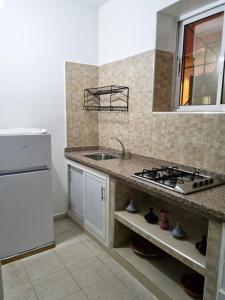 a kitchen with a sink and a stove at Maison l'océan in Rabat