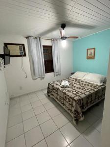 Schlafzimmer mit einem Bett und einem Deckenventilator in der Unterkunft Pousada Saint Germain in Búzios