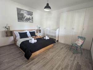 a bedroom with a large bed and a chair at Runaway Cottage in Unešić +28 photos