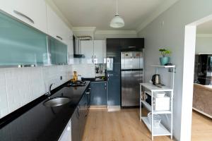 a kitchen with a sink and a refrigerator at Hill House in Trabzon