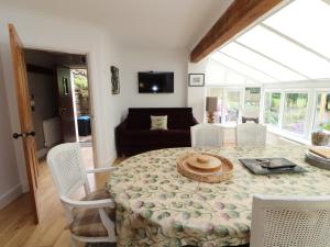 a dining room with a table and chairs and a couch at North Lodge in Annan