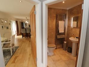 a bathroom with a toilet and a sink at North Lodge in Annan +47 photos