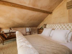 a bedroom with a large bed and a couch at The Tractor Shed in Preesgreen