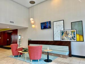a lobby with a couch and chairs and a table at Holiday Inn Toledo - Maumee I-80/90, an IHG Hotel in Maumee