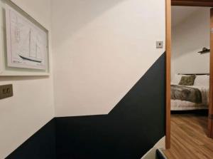 a bedroom with a black and white wall at WhereToStay Cosy 3bed House in Barrow in Furness
