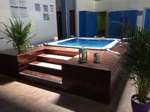 a swimming pool in a room with stairs and plants at Saval Spa Aqquaria Family Complex in Salou