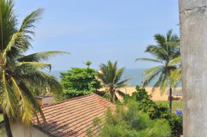 a view of the ocean from a resort with palm trees at Marshal Beach Guesthouse in Negombo