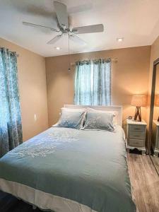 a bedroom with a bed with a ceiling fan at Rehoboth getaway/HotTub/EV/2bd/3.7mi beach/outlets in Rehoboth Beach