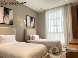 a bedroom with two beds and a window at Kease Ar Rabi F-7 Luxurious Creativity GX12 in Riyadh