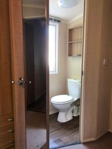 a bathroom with a toilet and a window at Popular property in Bembridge in Bembridge