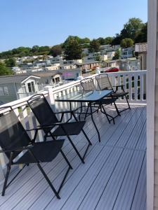 a deck with a table and chairs on a balcony at Popular property in Bembridge in Bembridge
