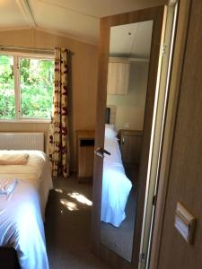 a hotel room with two beds and a mirror at Popular property in Bembridge in Bembridge