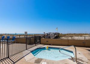 a swimming pool with a volley ball on top of a building at Phoenix All Suites West Hotel in Gulf Shores