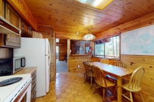 a kitchen and dining room with a table and a refrigerator at Cabin Chalet in Truckee