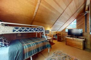 a bedroom with a bunk bed and a flat screen tv at Cabin Chalet in Truckee