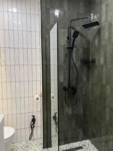 a shower with a glass door in a bathroom at Eka's apartment in Tbilisi City