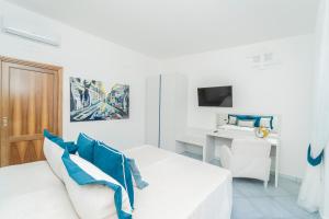 a white living room with a white couch and a desk at Residenza Sant'Angelo - Art Apartment in Minori