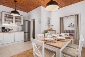 a kitchen and dining room with a wooden table and chairs at Apartments Carmen in Matulji