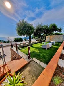 a garden with chairs and tables and a fence at Acquamarina in Gaeta