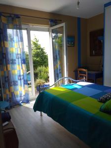 a bedroom with a bed and a large window at Welcome in Pontivy
