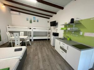 a large room with a kitchen and a dining room at Tutti Apartman in Balatonlelle