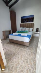 a bedroom with a large bed in a room at Finca Hotel Zona Franca in Rionegro