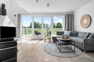 a living room with a couch and a tv at Große Freiheit in Olpenitz