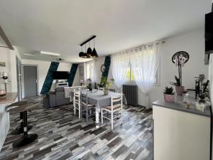 a living room with a dining table and a kitchen at Maison avec jardin centre ville in Saint Lo