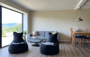a living room with a couch and a table at Valley House in Notodden +11 photos