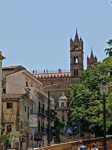 a building with a clock tower and a church at PAIPER B&B in Palermo