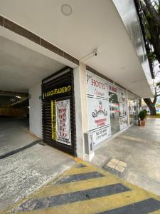 a store with signs on the side of a building at Hotel Monaco in Tuluá