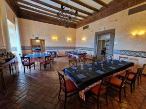 duża jadalnia z niebieskimi stołami i krzesłami w obiekcie Castillo de Illueca w mieście Illueca
