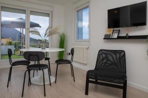 a dining room with a table and chairs and a tv at HOGAR DEL MAR in Oia