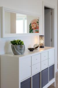 a white cabinet with a plant on top of it at HOGAR DEL MAR in Oia