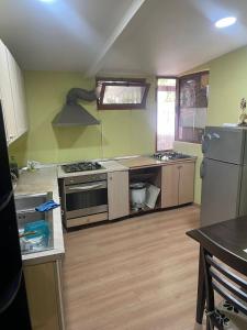 a kitchen with a stove and a refrigerator at Top view hostel in Durrës