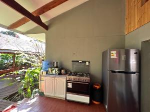 a kitchen with a stove and a refrigerator at Te Ariki - Adults Only in Hanga Roa