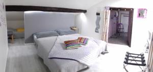 a bedroom with a bed with two pillows on it at Chambre d'Hôtes Chez Eliane et Bernard in Lisle-sur-Tarn