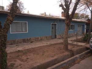 a blue house with a tree in front of it at Casita de mis viejos in Mendoza