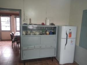 a kitchen with a white dresser and a refrigerator at Casita de mis viejos in Mendoza