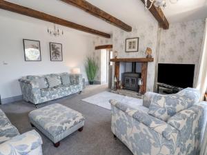 a living room with two couches and a fireplace at Cunliffe House in Shipley