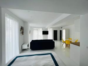 a bedroom with a black bed and a table at Oxygen Residence D3 in Neptun